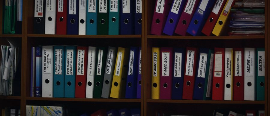Shelves of labelled document binders in a records office